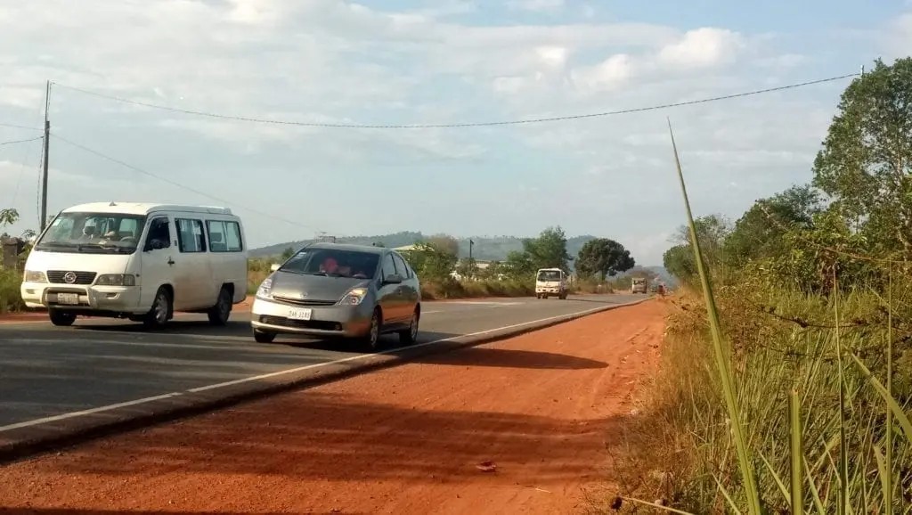 Car overtaking van on Cambodia's highway 4