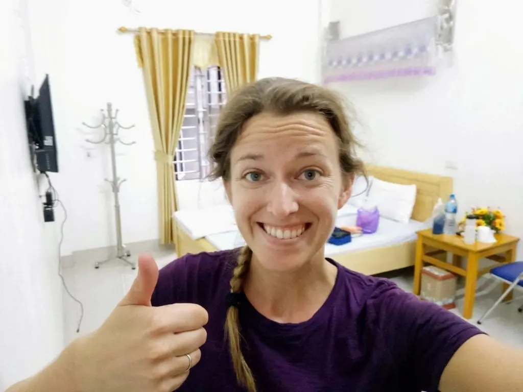 Happy cyclist in clean guesthouse room