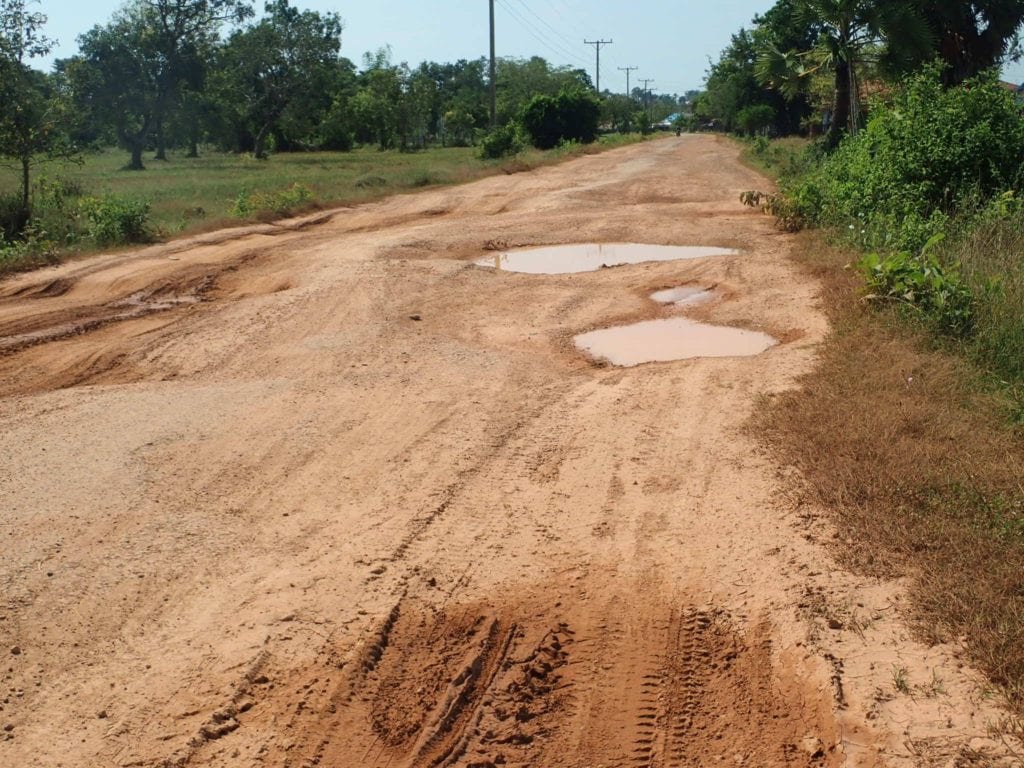 Dirt road with puddles in Laos