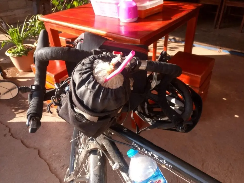 Bicycle handlebar bag holding iced coffee