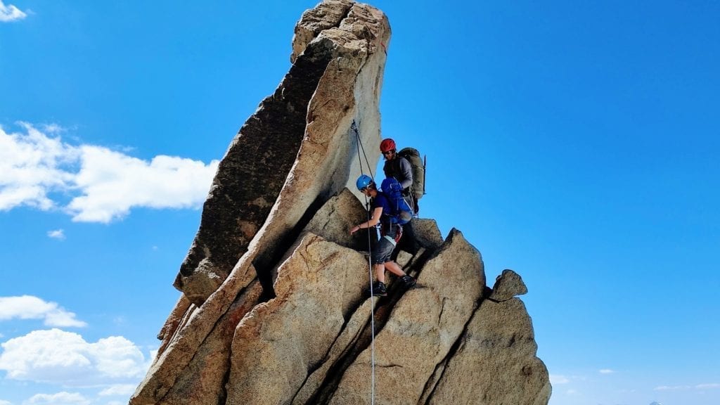 Climber downclimbing class 4 with a guide in the Palisade range