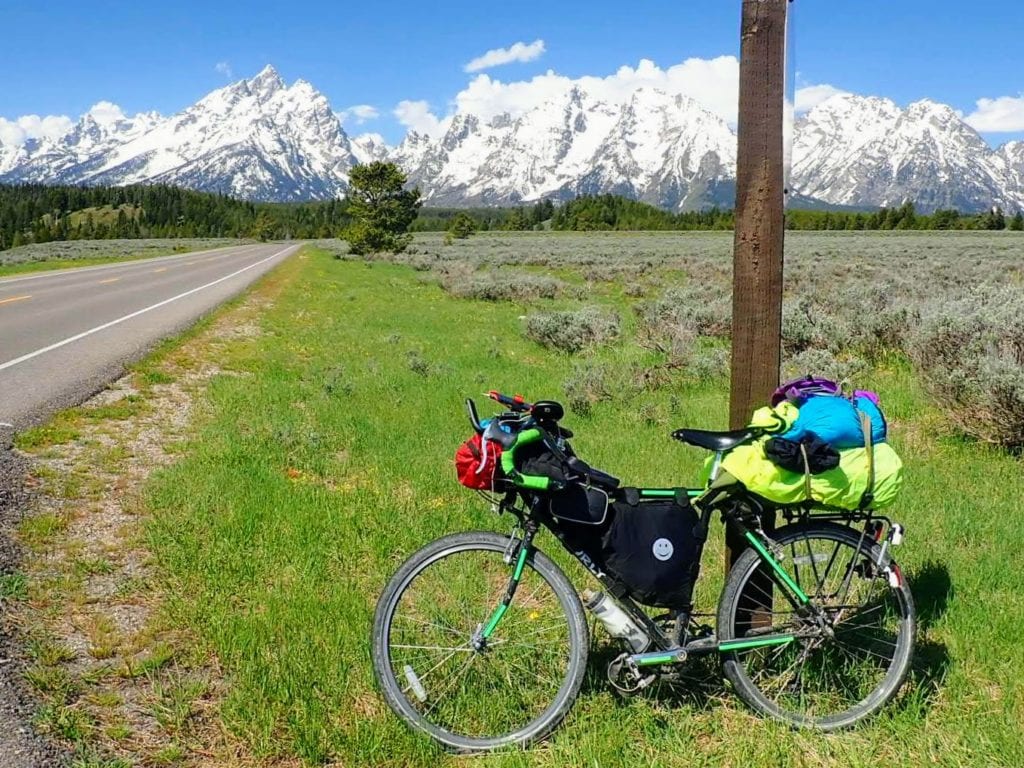 Bicycle against sign on road through Teton National Park