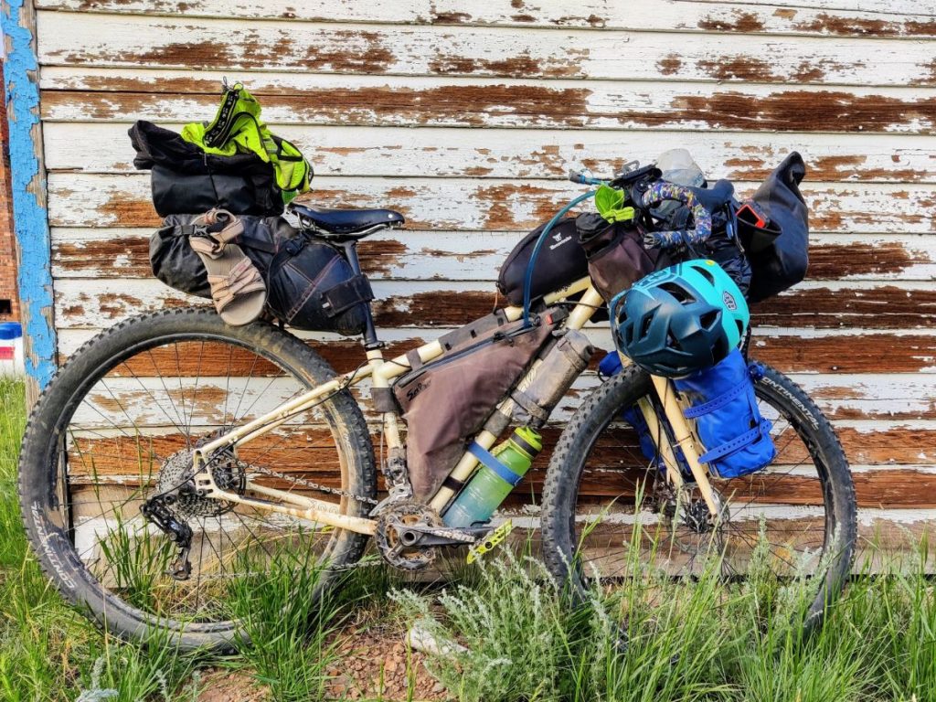 Salsa Fargo loaded bike leaning against wooden building