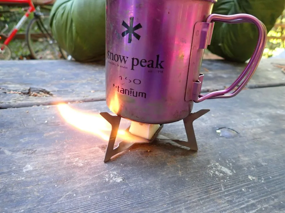 https://exploringwild.com/wp-content/uploads/2020/06/Esbit-stove-and-titanium-mug.jpg