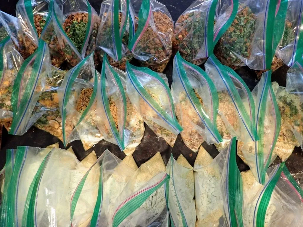 Preparing backpacking meals in many plastic bags