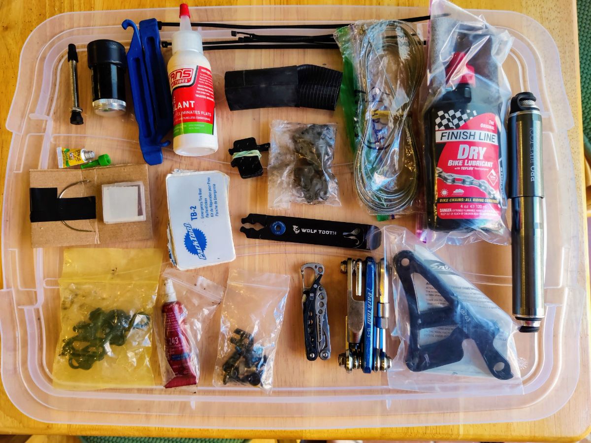 Bikepacking repair kit pieces laid out on table