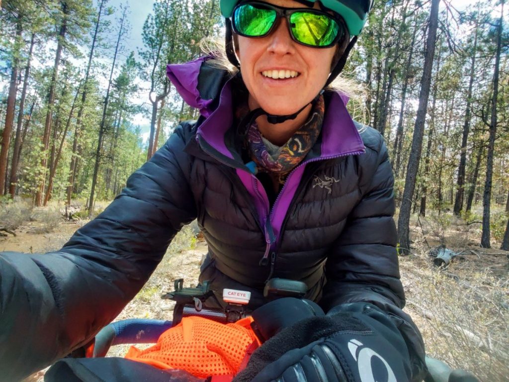 Woman wearing warm layers while bikepacking in Central Oregon