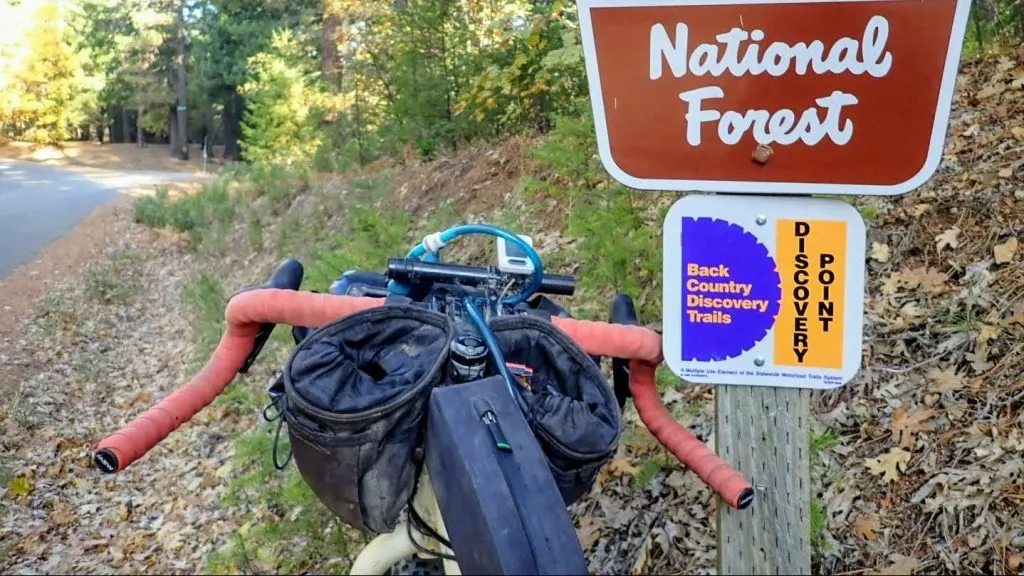 Bike with Woodchipper handlebars leans against national forest sign