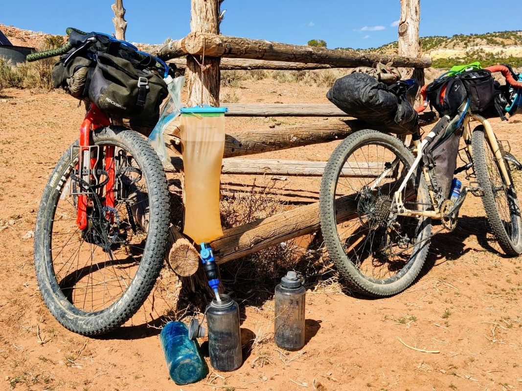 https://exploringwild.com/wp-content/uploads/2021/11/Filtering-water-while-bikepacking-in-Utah-edited.jpg